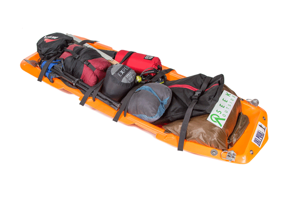 Orange EraPro Paris Expedition pulk sled packed with winter camping gear.