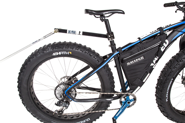 SkiPulk fatbike pulk pulling hitch shown on a fat bike with poles connected.
