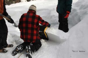 Igloo Ed kneeling and positioning the ICEBOX Igloo Tool